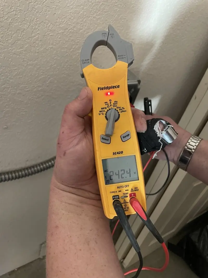 Voltage testing with clamp meter during Recessed Lighting Installation in Marilla